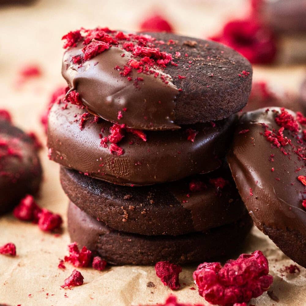 A stack of 4 chocolate shortbread cookies.