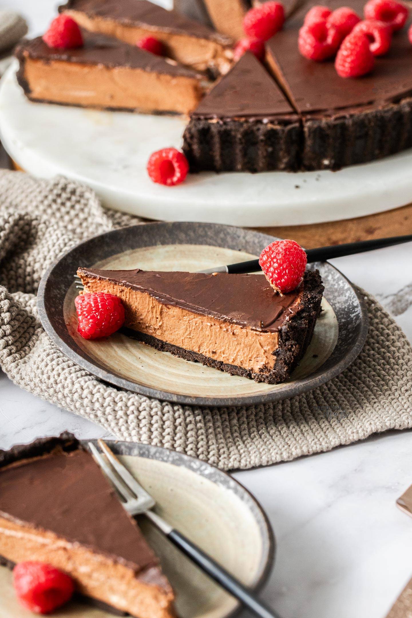 A slice of chocolate mousse tart on a dessert plate.