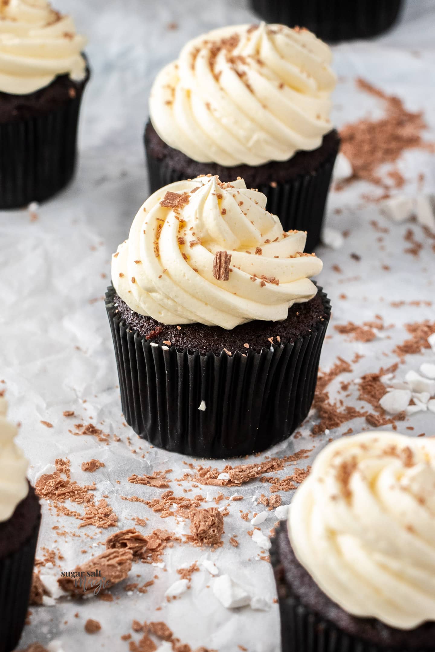 Closeup of a chocolate cupcake topped with peppermint frosting.