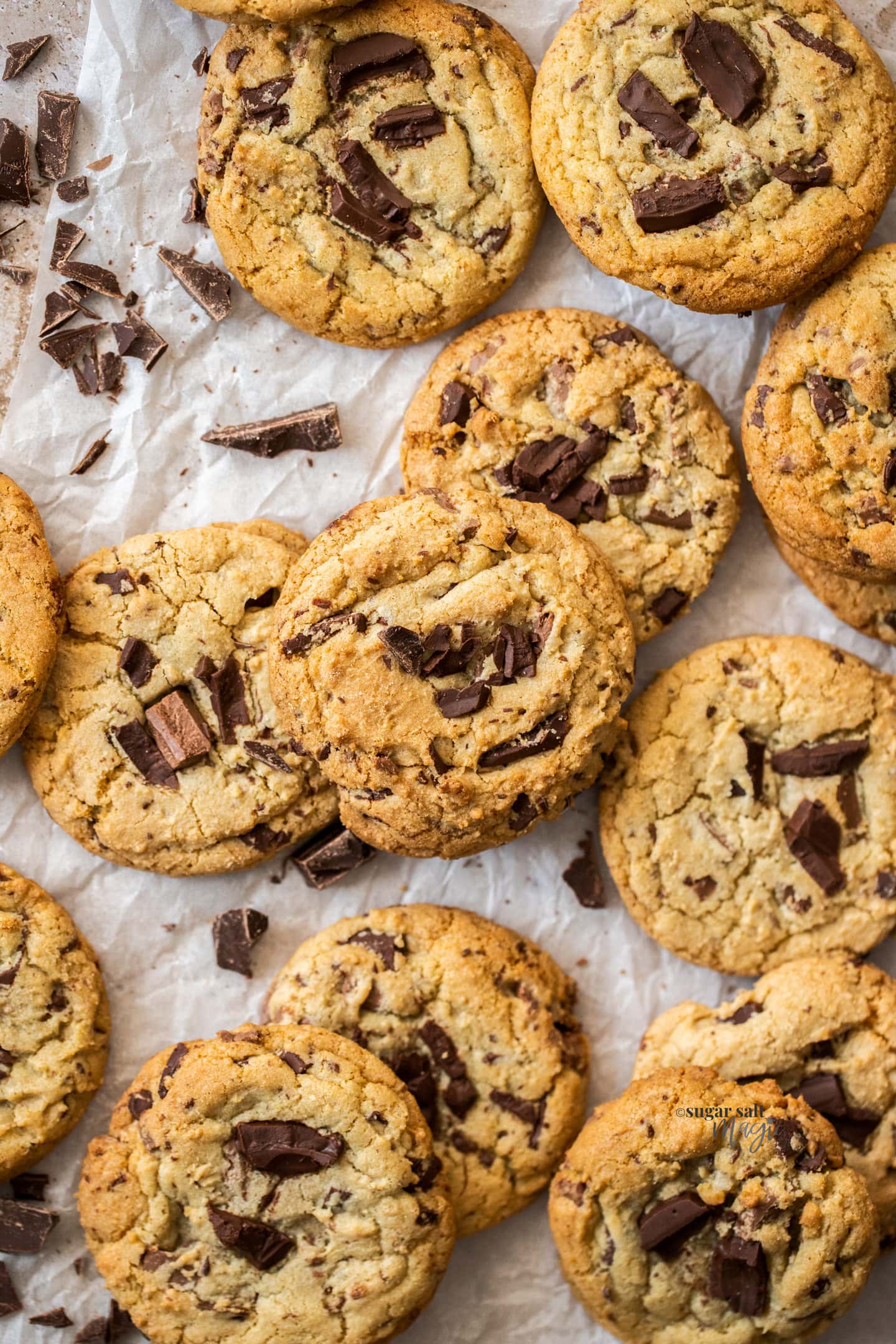 Top down view of a pile of chocolate chunk cookies.