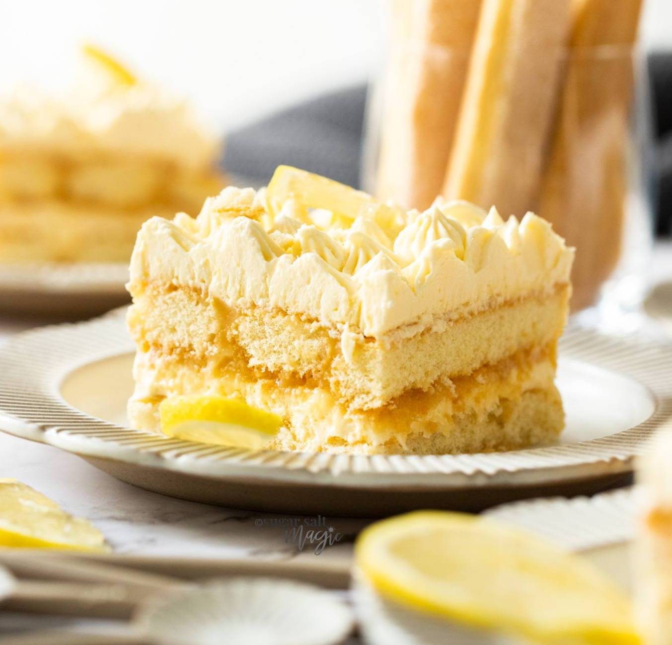 A square of lemon tiramisu on a dessert plate.