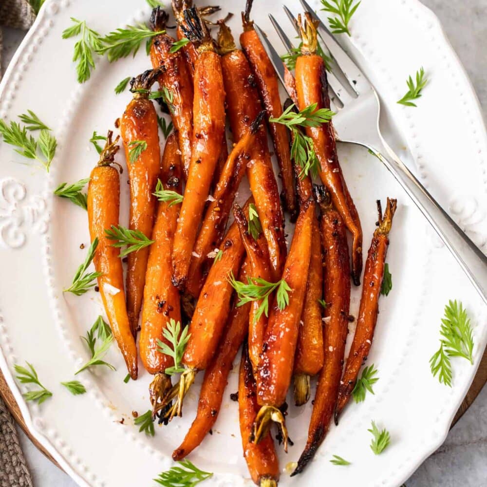 Top down view of a plate of roasted maple carrots.