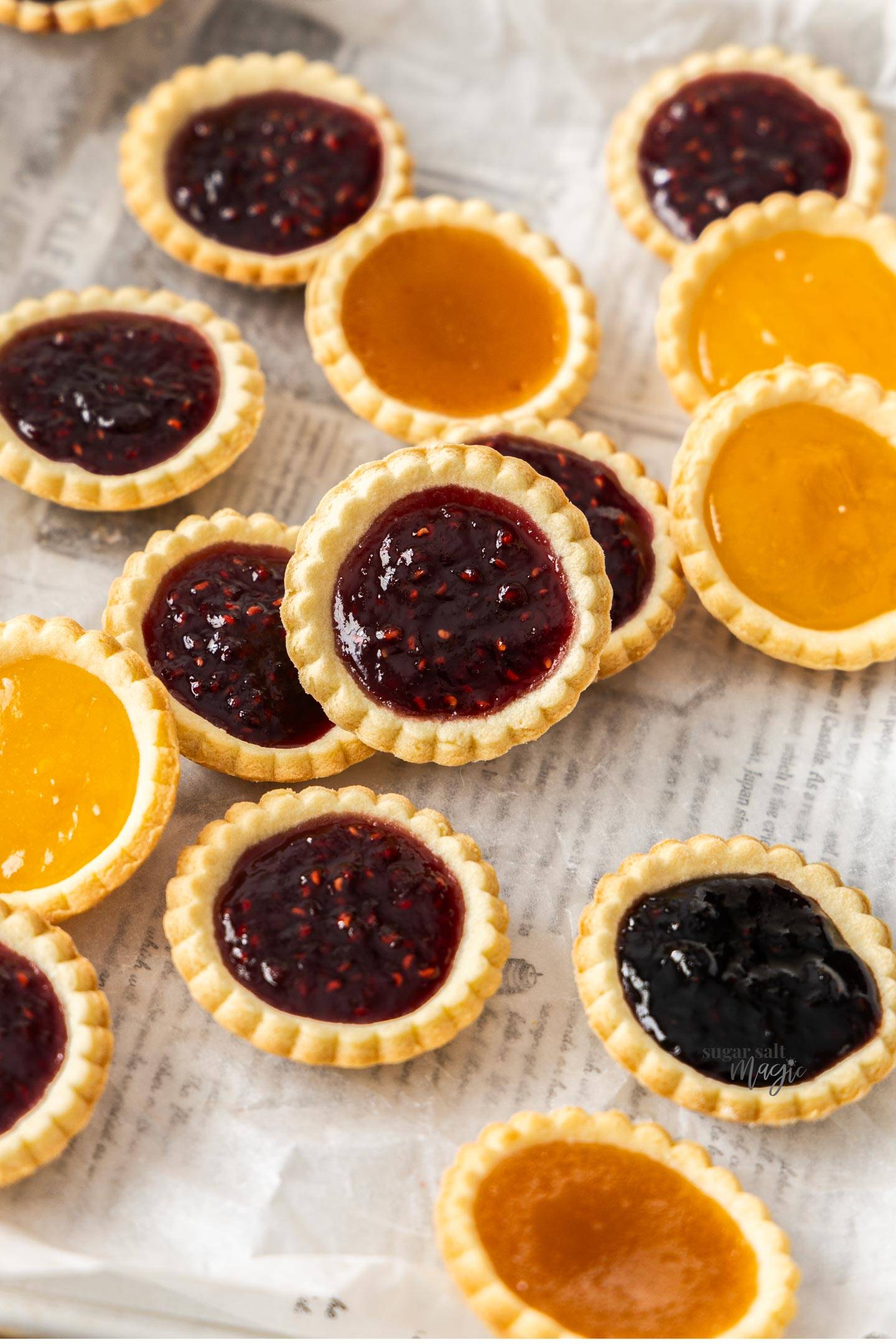 A batch of jam tarts on a serving board.