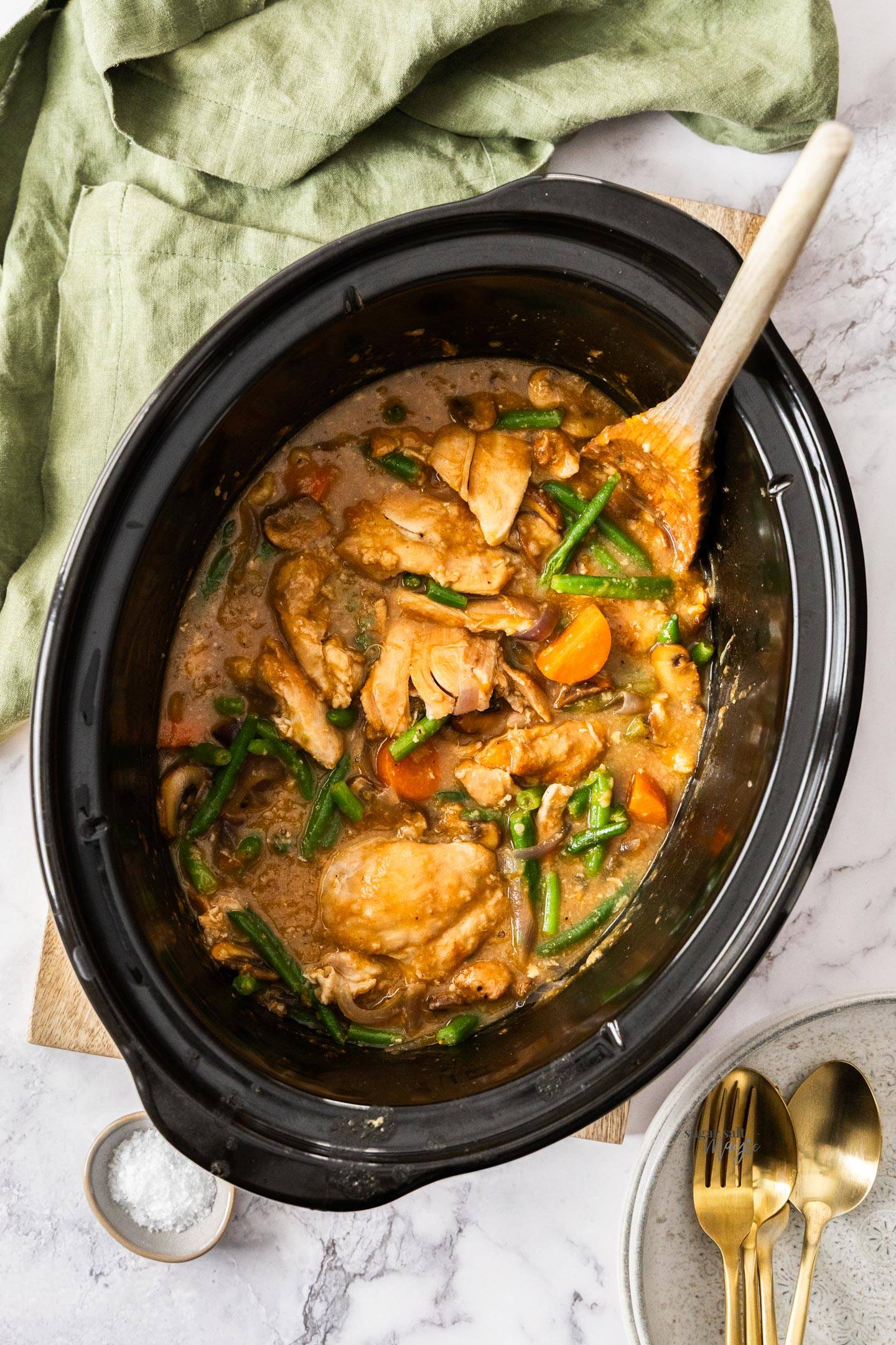 Top down view of a slow cooker bowl filled with apricot chicken.