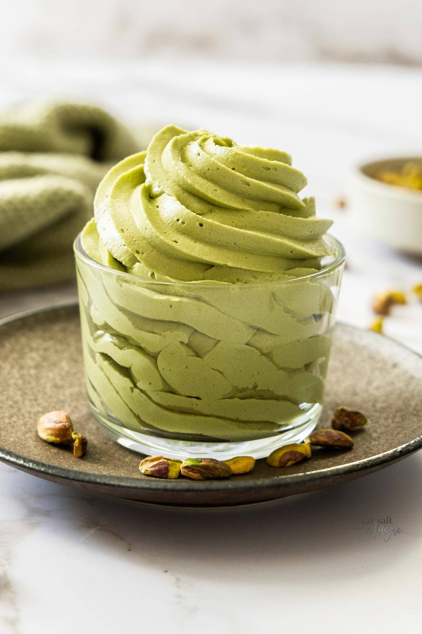 A big swirl of pistachio frosting in a glass.