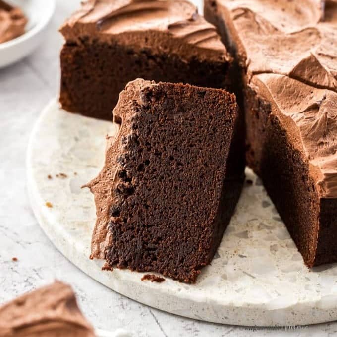 A slice of chocolate mud cake laying on it's side.