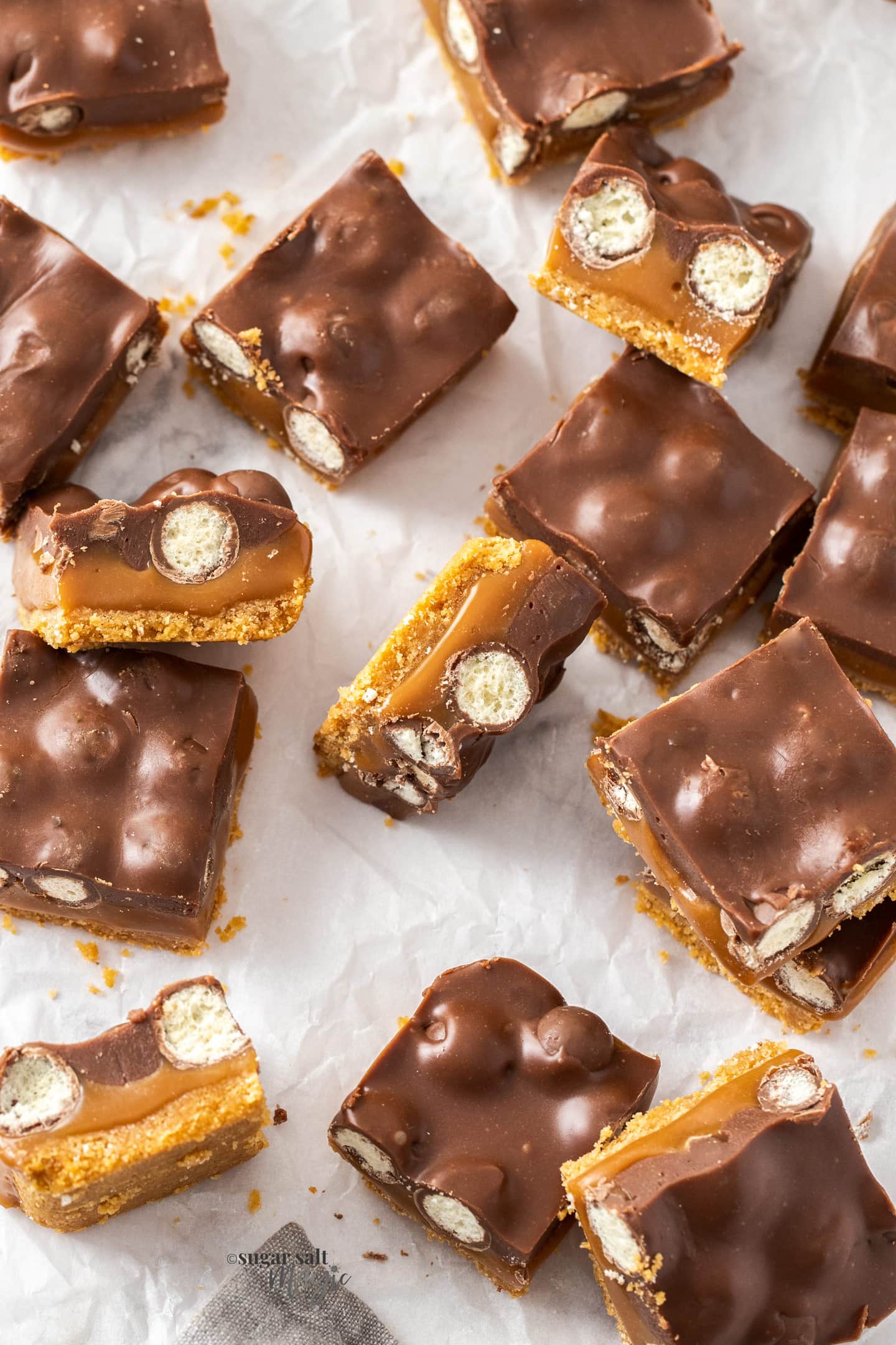 Top down view of squares of caramel Malteser slice.