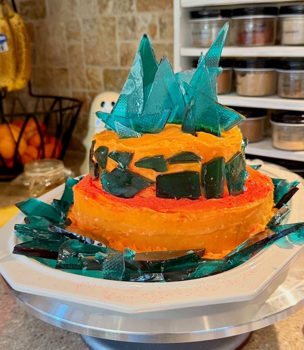 orange tiered cake with blue sugar glass shards