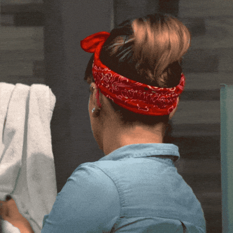 woman in a retro outfit dramatically turning her head towards the camera