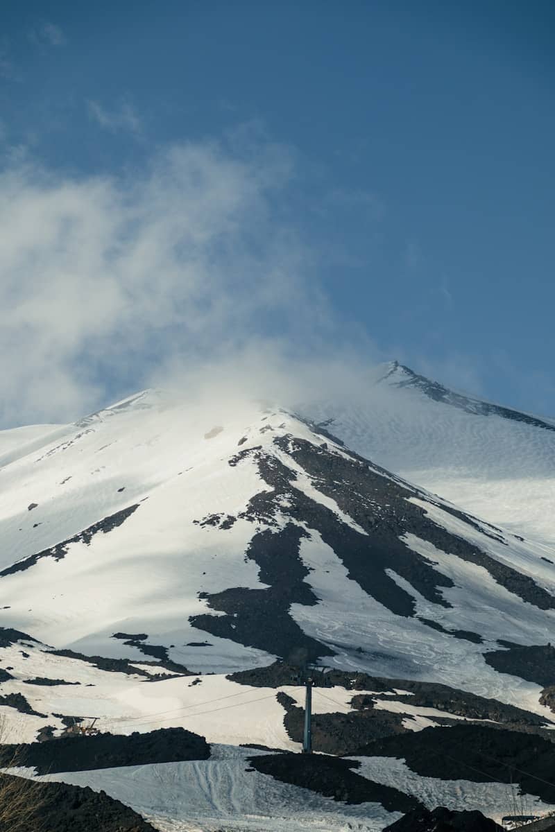 Snow-covered mountains under a blue sky
