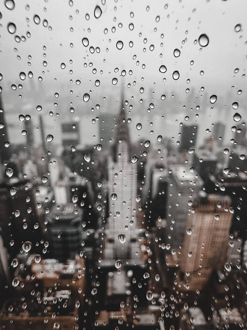 Raindrops on window overlooking new york city skyline.