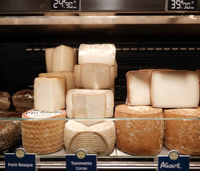 Assortment of cheeses displayed in a shop.