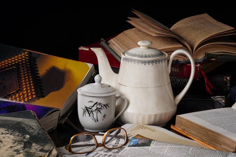 Books, teapot, and glasses make a cozy still life.