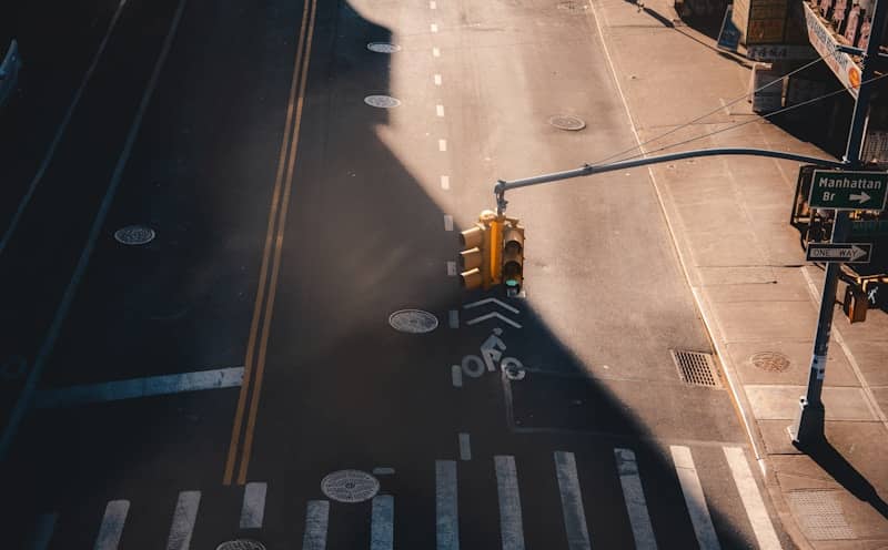 Empty street with yellow traffic light.