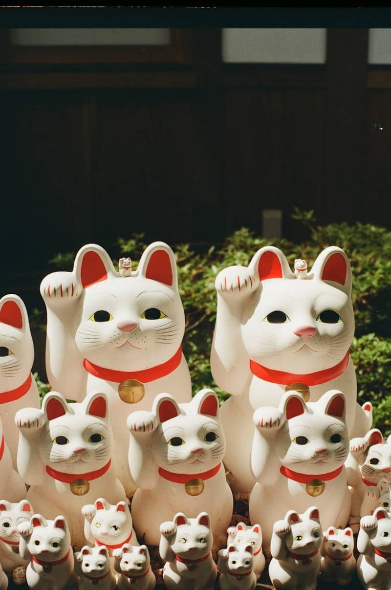 Maneki-neko cats are waving for good luck.