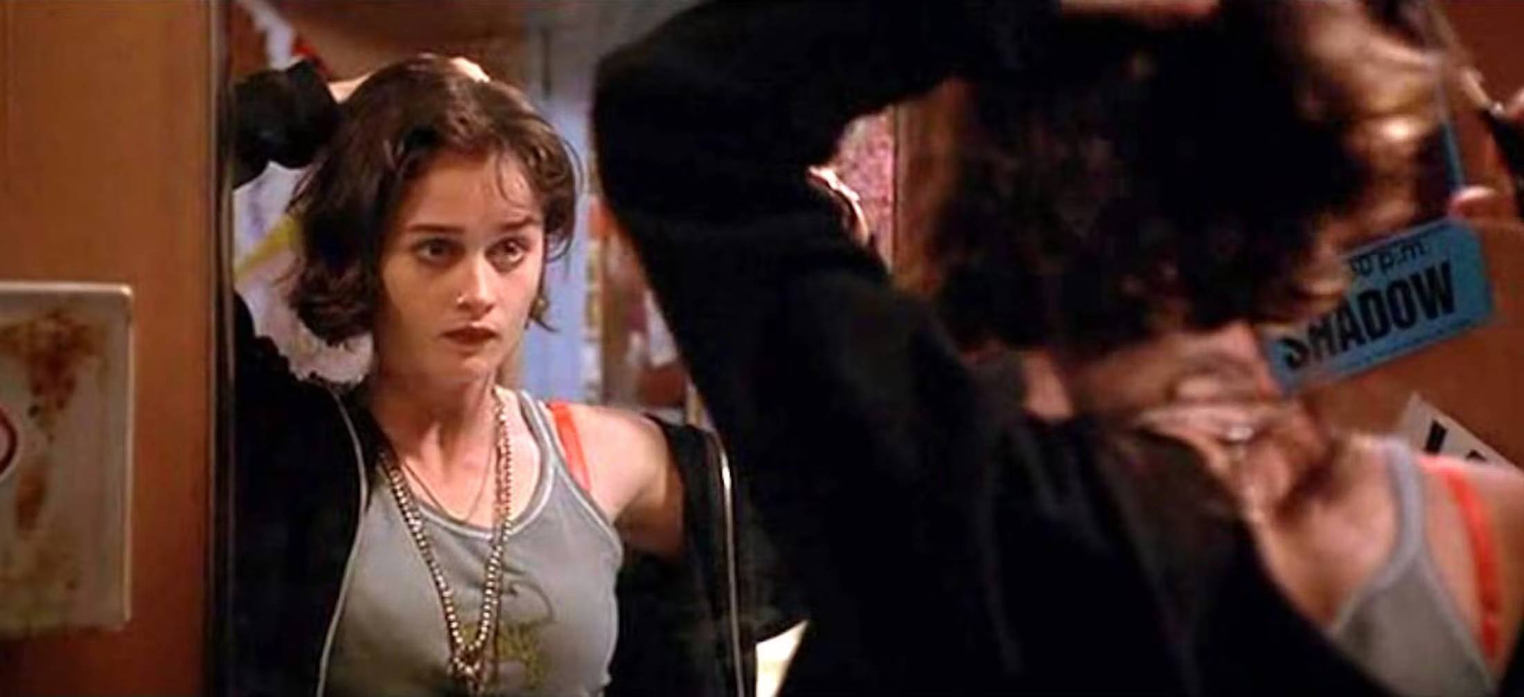 Deb from Empire Records shaving her head in a mirror