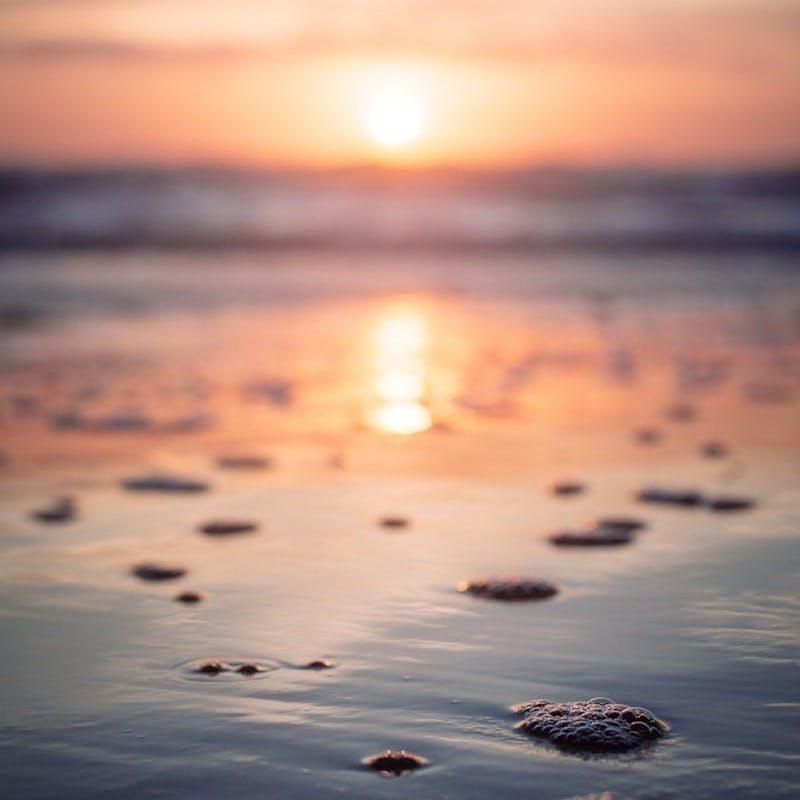 reflection of sunset on beachshore