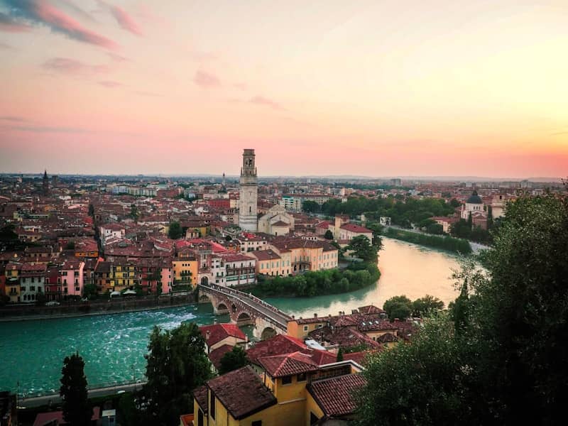 Cityscape with river and bridge at sunset