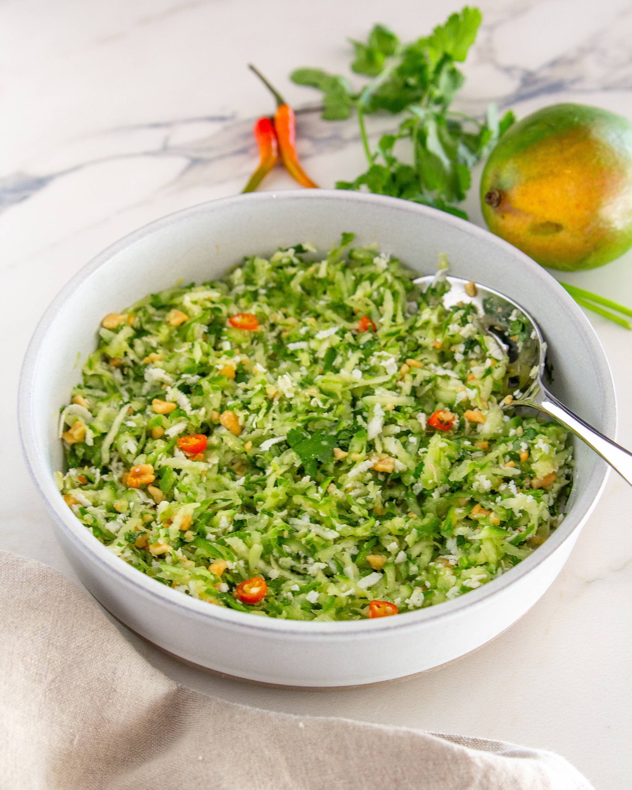 Crunchy cucumber, tart green mango, fresh coconut, and roasted peanuts come together in this vibrant summer salad.