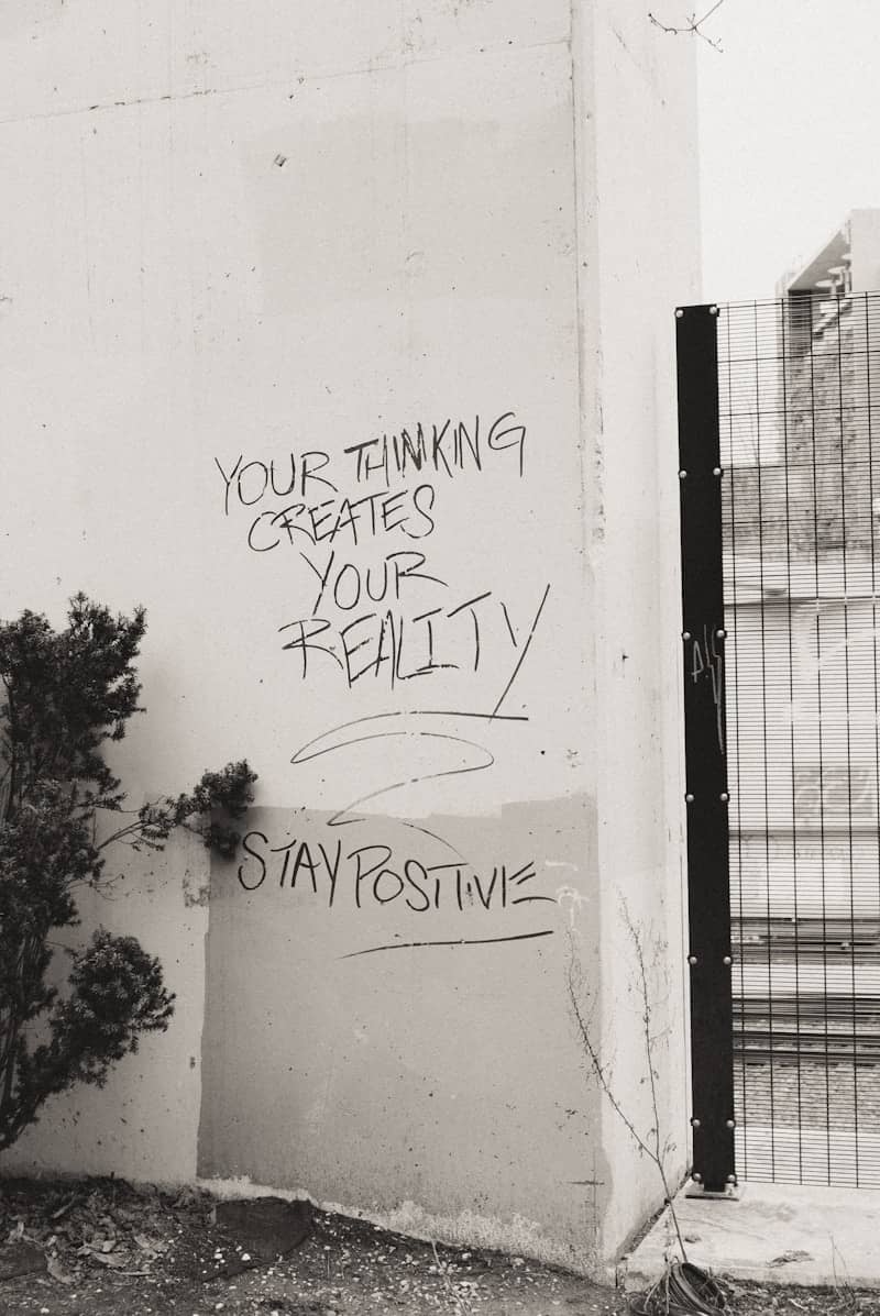 a black and white photo of graffiti on a wall