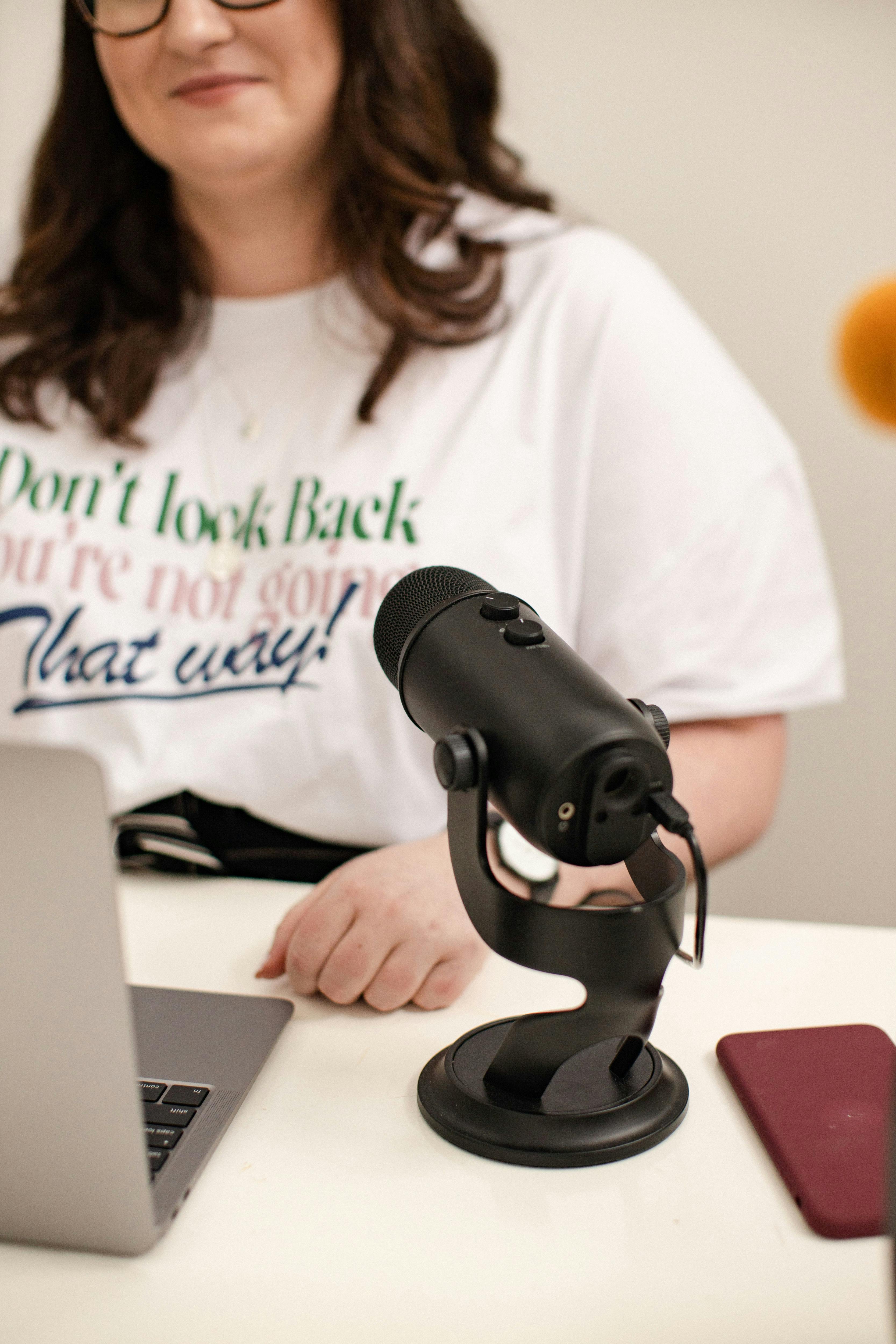 Photo of Emma with her laptop and microphone