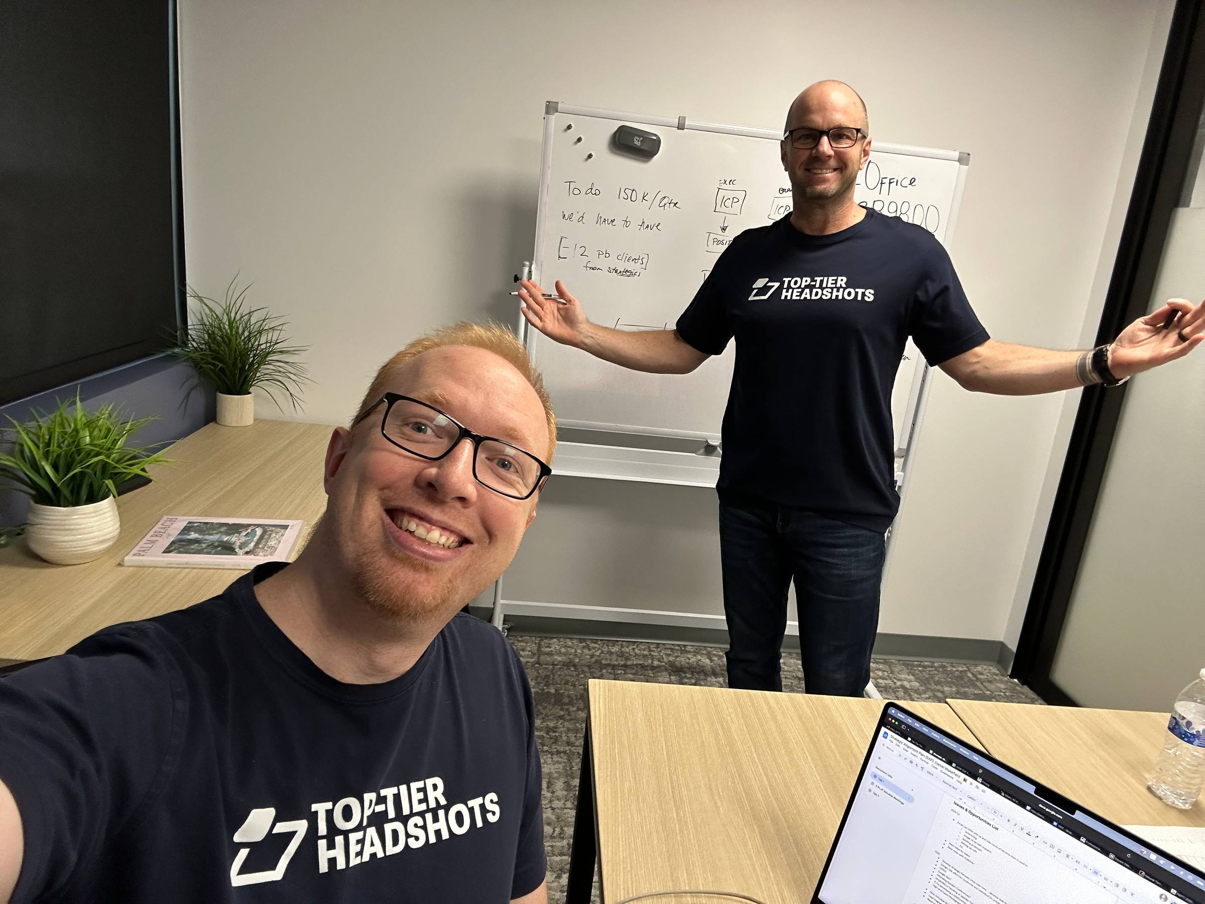 Daniel Wakefield and entrepreneur Nick Berry in a strategic planning meeting with a whiteboard in the background.