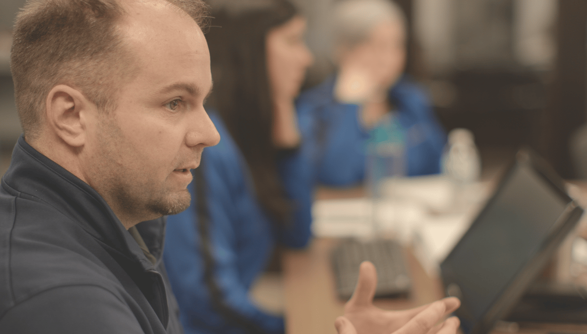 Nick Berry speaking during a roundtable business coaching session, discussing leadership and decision-making with other business owners.