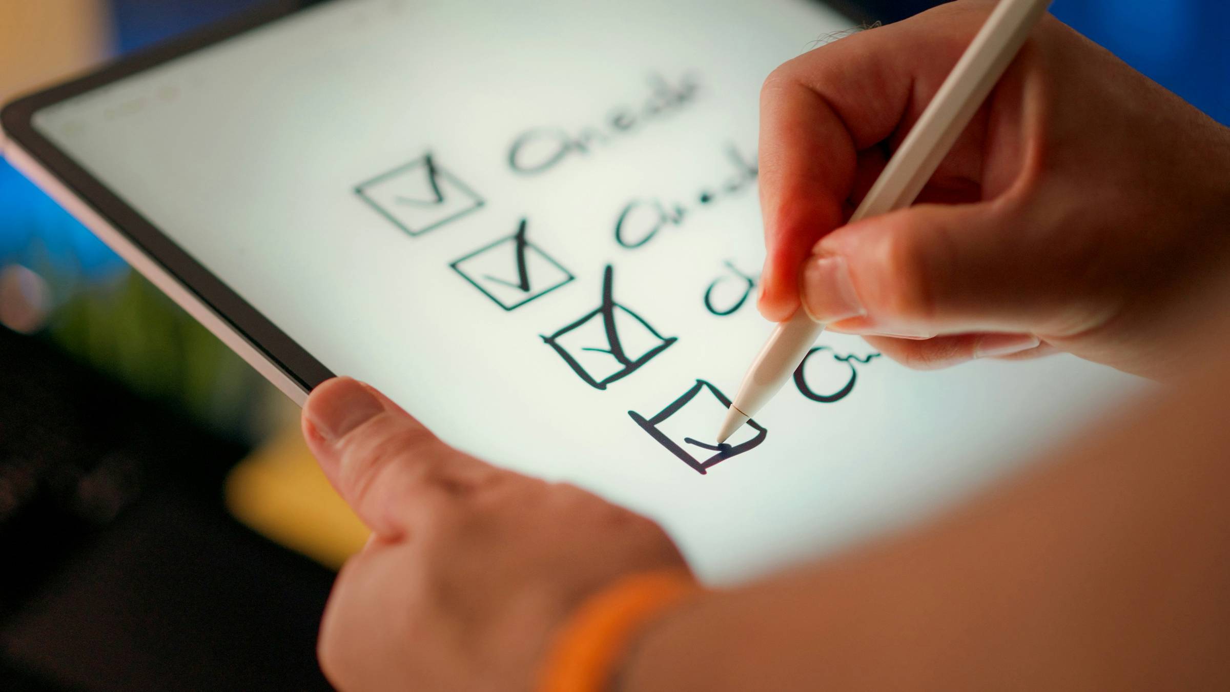 A person checking four boxes on a tablet, each box labeled "Check"