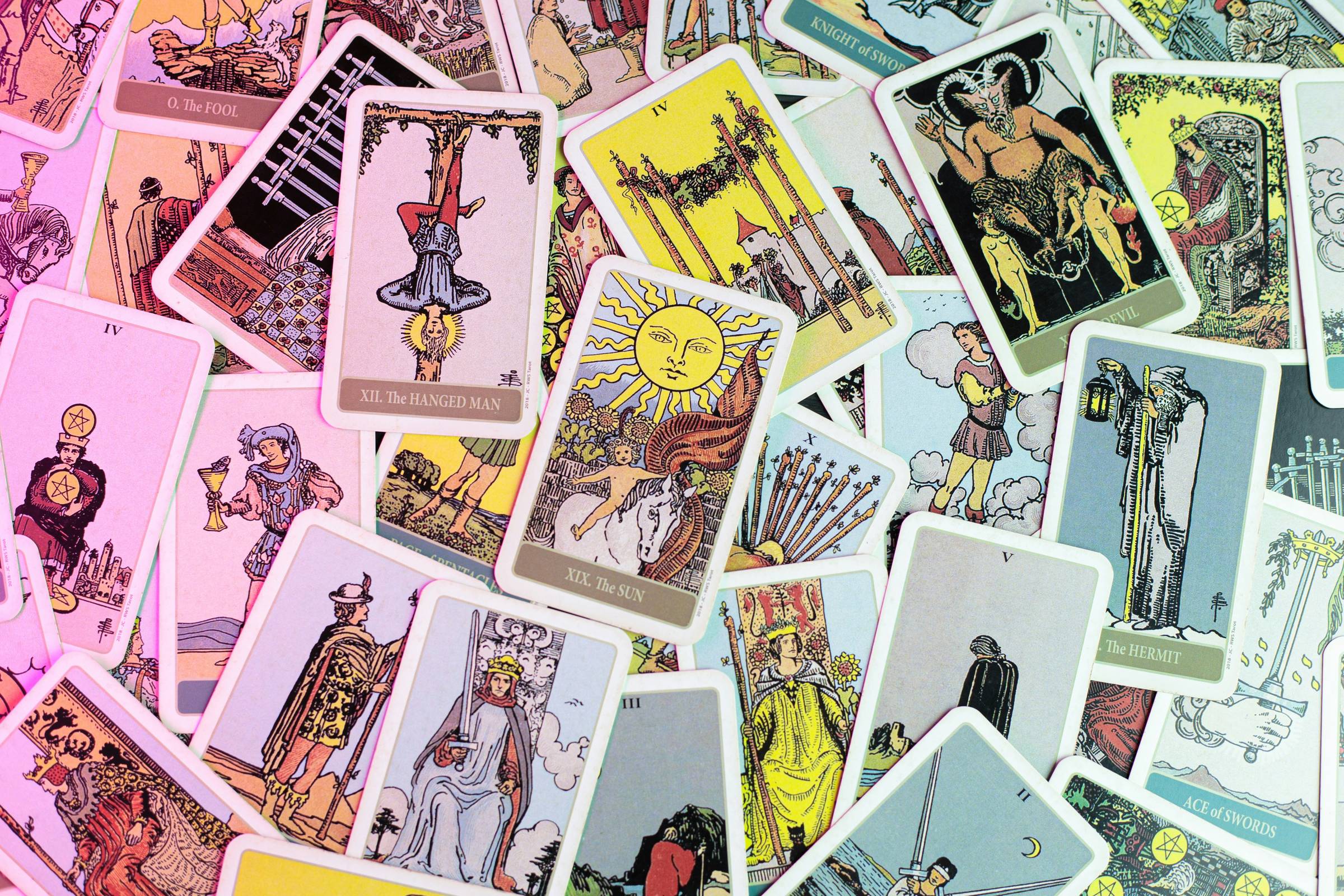 A bunch of tarot cards spread out