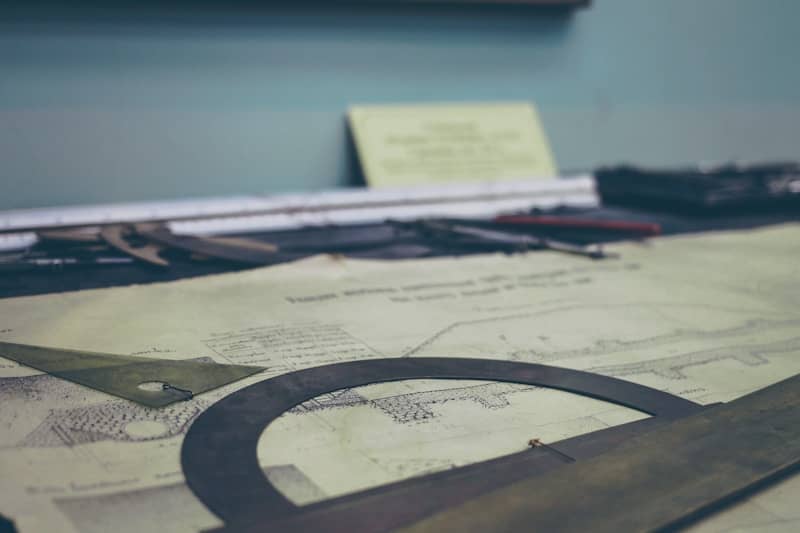 beam design printed paper on desk, with a protractor on top