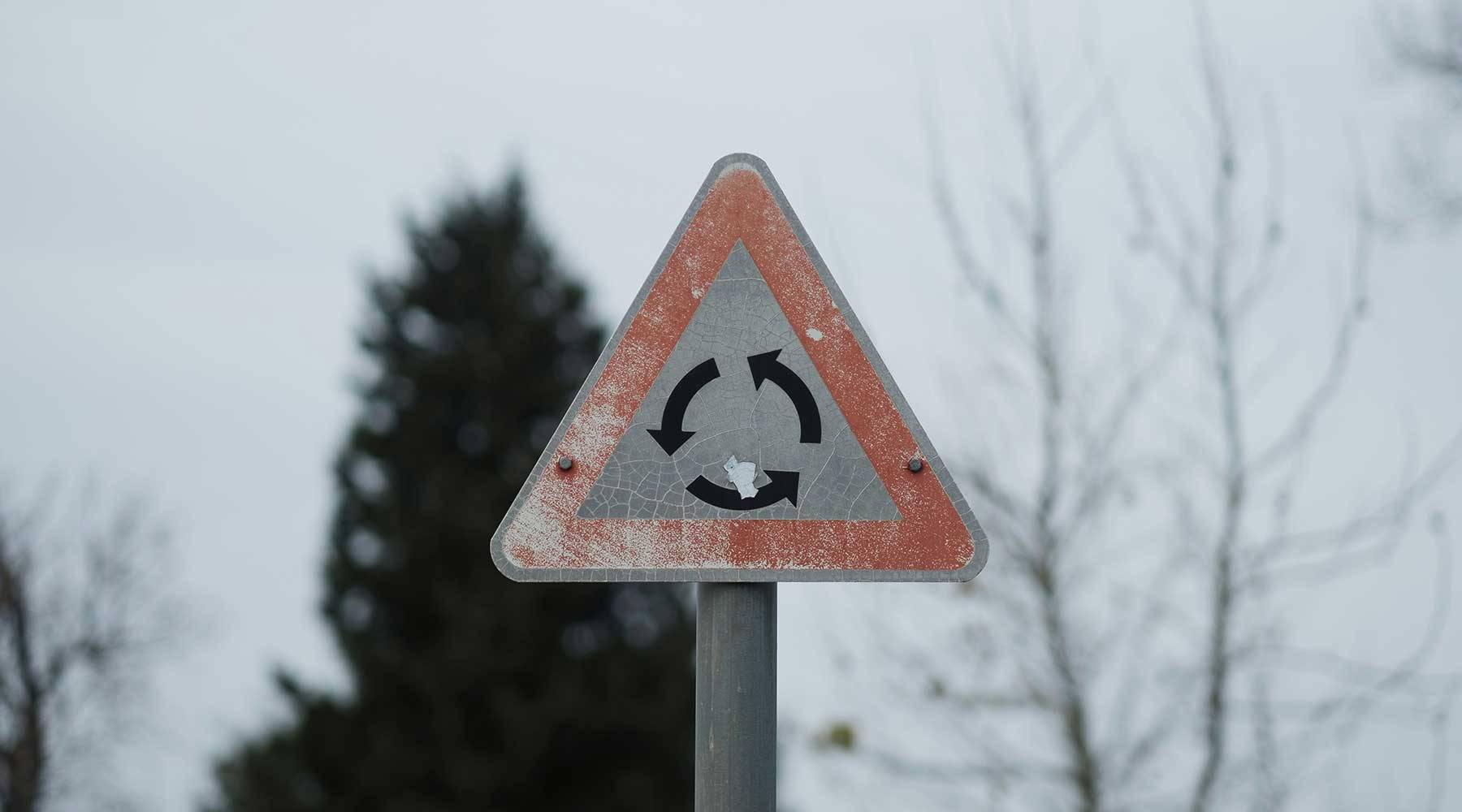 reverse roundabout sign