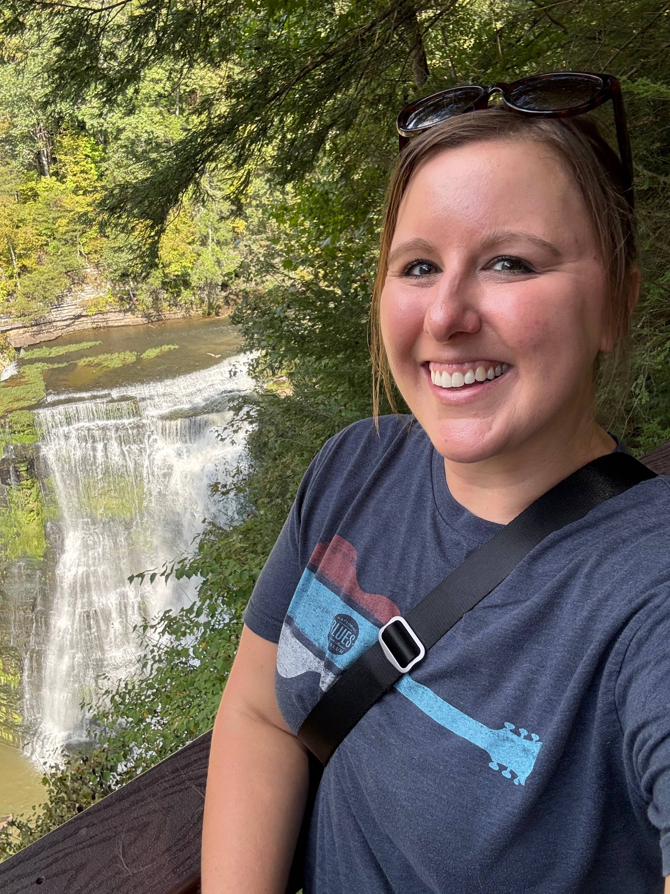 Katie Rockey at the Burgess Falls State Park in front of a waterfall in Tennessee