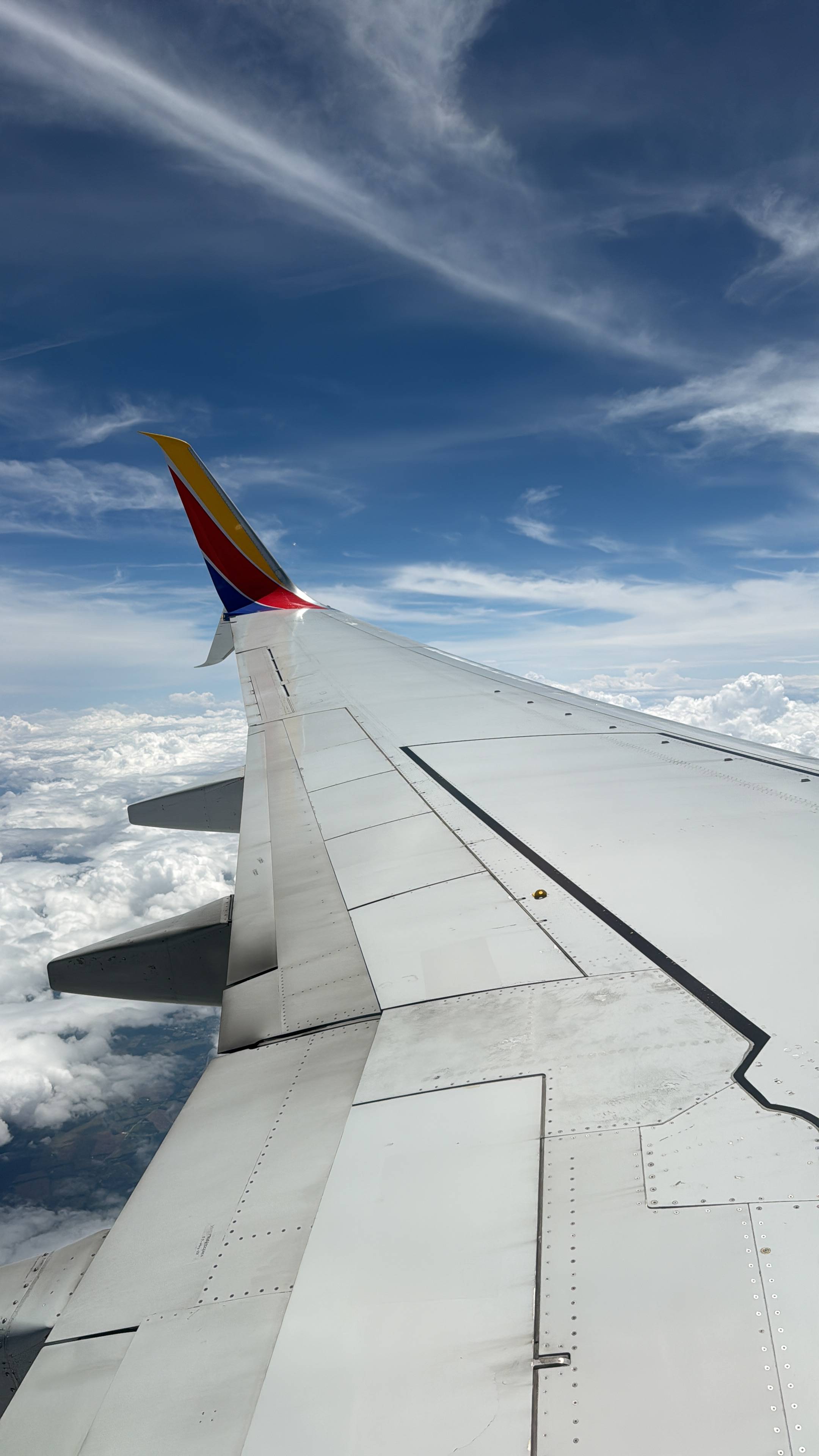 View out window of Southwest flight above the clouds