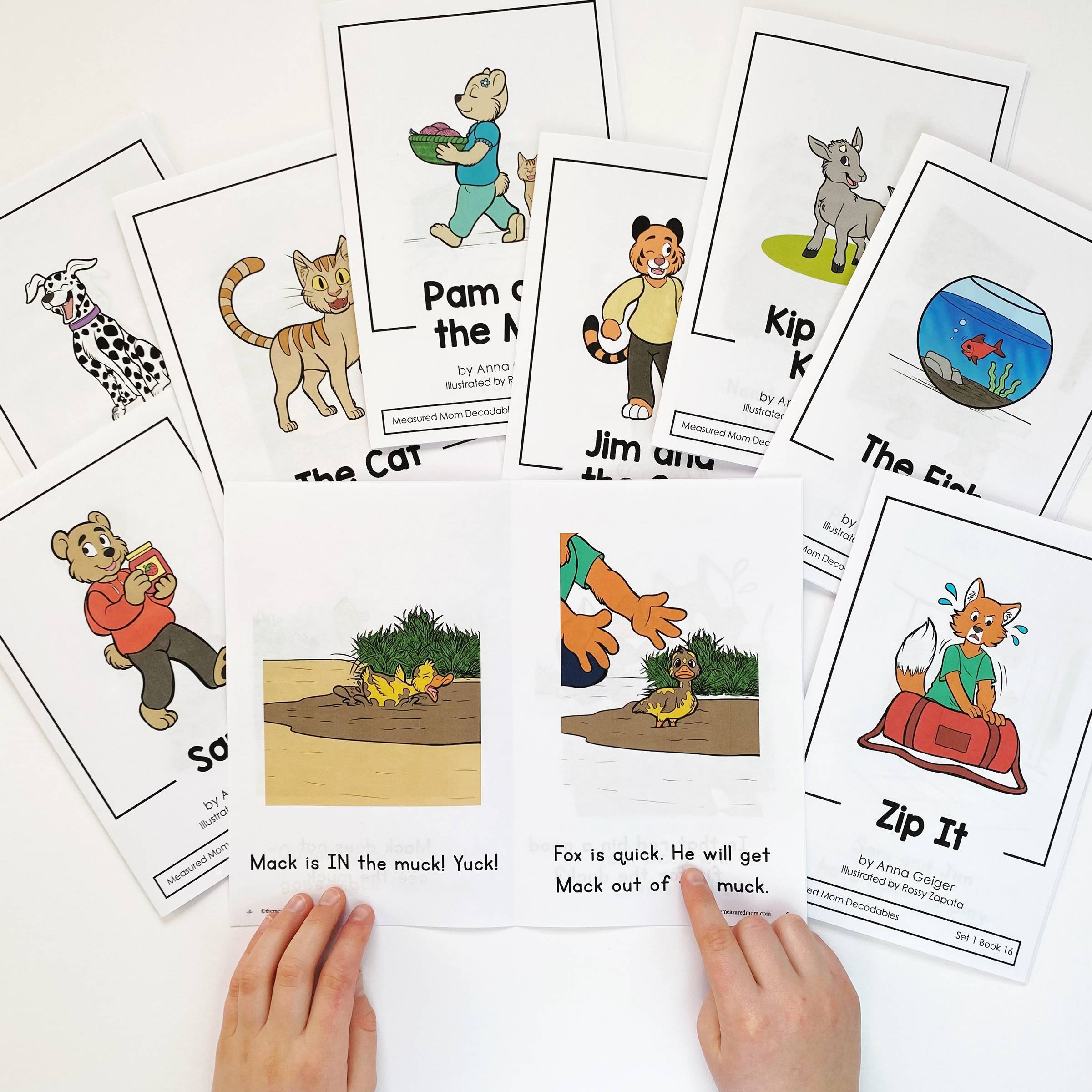 Decodable books from Reach All Readers spread out on a table